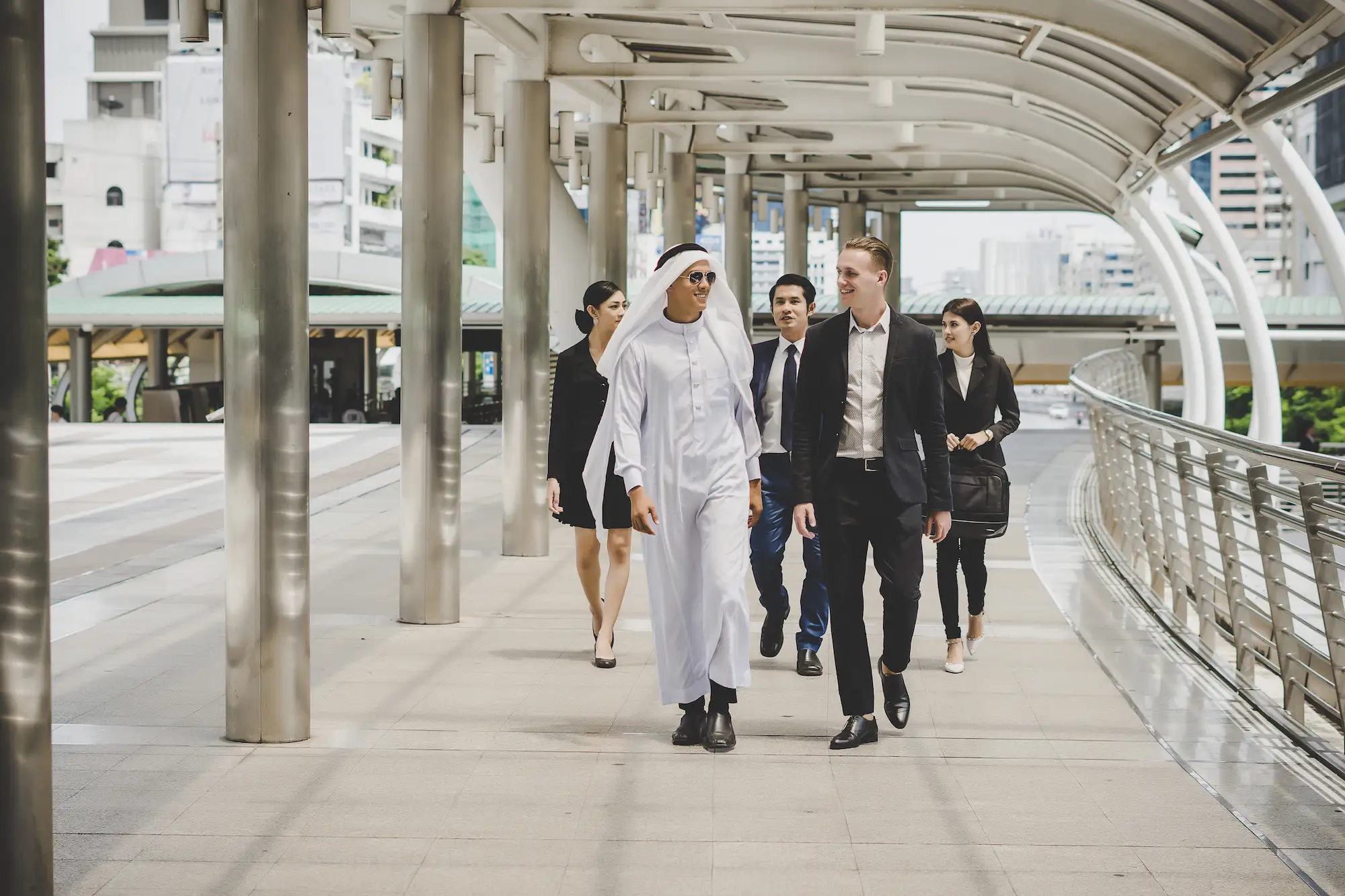 business-partners-team-walking-down-discussing-work - Cyber security in ajman